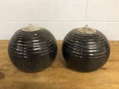 Pair of ribbed spherical lanterns with inserted galvanised pots which hold oil and wick