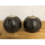 Pair of ribbed spherical lanterns with inserted galvanised pots which hold oil and wick