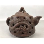 Chinese Yixing Clay teapot with Oval impressed marks to base. Outer shell has pierced decoration