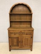 Small oak dresser with arched top and linen fold detailing to cupboards