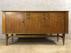 Mid Century sideboard with four drawers and three cupboards on tapered legs, approx 156cm x 46cm x