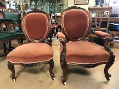 Pair of 'His and Hers' Victorian bedroom chairs with carved detailing and ceramic castors