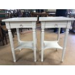 Pair of white painted occasional tables with tapered legs, single drawers and shelf under, each