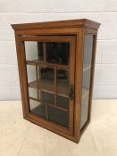 Glazed wooden hanging cupboard with single door and two internal shelves