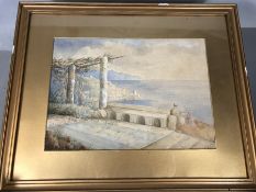 Framed watercolour of a Mediterranean coastal scene, indistinct signature lower right M.E.B., approx