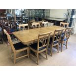 Large modern pine extending dining table on twin pedestal base with eight matching chairs with