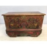 Large Eastern-style chest with heavily carved hand-painted scenes, brass detailing and cast iron