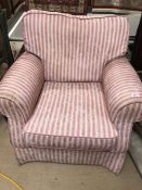 Single upholstered armchair in pink and white striped fabric