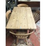 Pine kitchen table and four slat-back chairs, table approx 122cm x 77cm x 77cm tall