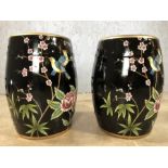 Pair of black porcelain barrel seats / stools, approx 46cm in height