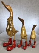 Set of three wooden graduating ducks in wellies, the tallest approx 48cm in height
