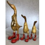 Set of three wooden graduating ducks in wellies, the tallest approx 48cm in height