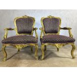 Pair of gilt framed chairs with purple upholstery