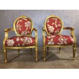 Pair of gilt framed chairs with red floral upholstery