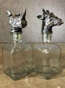 Pair of glass decanters, one with a Rhino head , the other a giraffe, each approx 24cm in height