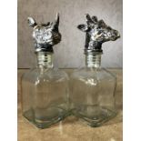 Pair of glass decanters, one with a Rhino head , the other a giraffe, each approx 24cm in height