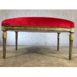 Large contemporary gilt framed upholstered stool in red fabric, approx 115cm x 60cm x 63cm tall