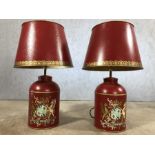 Pair of red Toelware lamps with painted emblem, approx 70cm in height