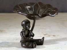 Small bronze figure of a Japanese child holding a lily pad, approx 5cm in height