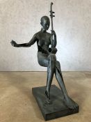 Abstract contemporary figure holding an instrument, approx 83cm in height