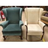 Two upholstered wing back armchairs