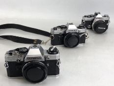 Two Olympus OM-10 camera bodies and one Olympus OM-2 body, 50mm F/1.8 (on-/off switch missing) along