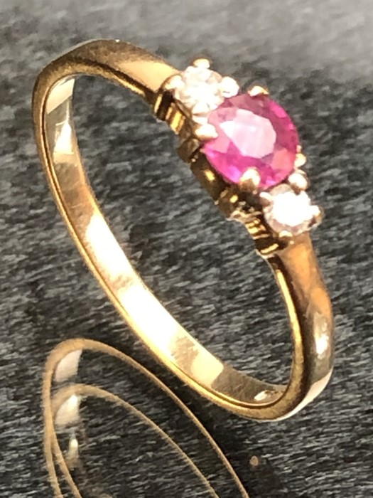 9ct Gold ring set with a single ruby and with Diamond shoulders size M