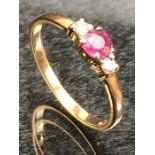 9ct Gold ring set with a single ruby and with Diamond shoulders size M