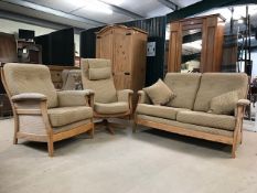 Modern Ercol three piece suite to include two seater sofa, armchair and reclining swivel chair, in