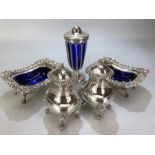 Silver plated cruet set with blue glass liners, salts, sugar shaker etc.....