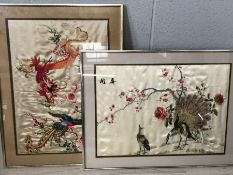 Two Chinese hand embroidered framed silks depicting dragons and peacocks each approx 62cm x 47cm