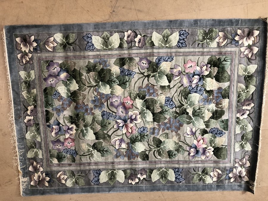 Chinese silk steel blue ground rug with exotic floral design, approx 170cm x 243cm
