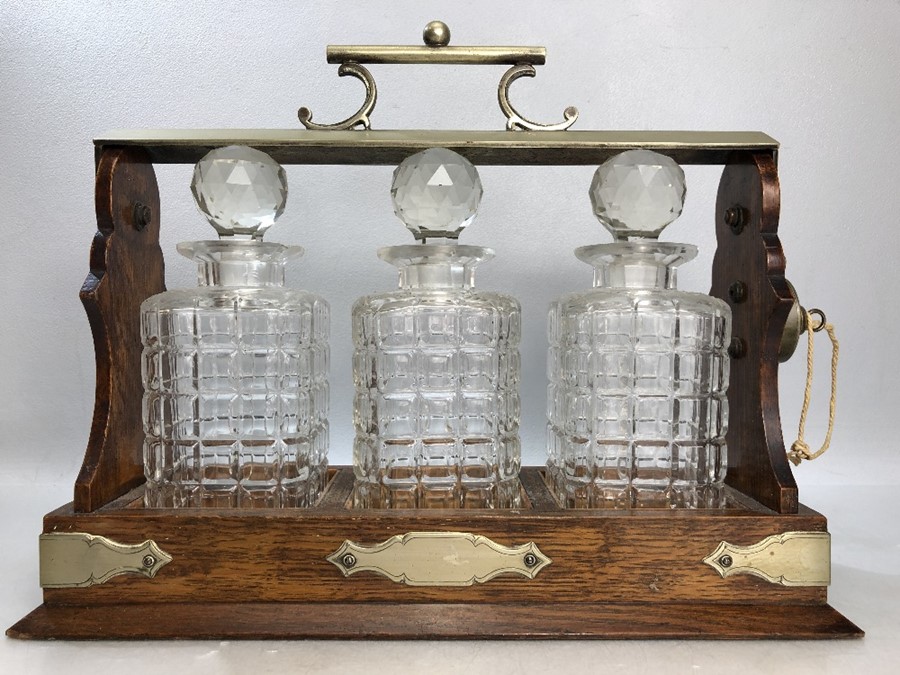 TANTALUS by DANIEL AND ARTER of Birmingham with unengraved Cartouche (some chips to decanters)