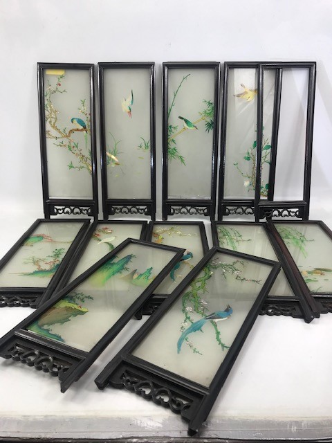 Collection of hand painted Chinese glass screens depicting birds in pierced wooden frames,