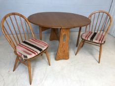 Blonde Ercol gateleg table, approx 121cm x 106cm extended, along with two Ercol stick back dining