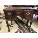 Small writing desk / console table with three drawers and brass fittings on carved legs, approx 74cm