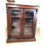 Two door glazed mahogany bookcase with three shelves and original key, approx 92cm x 28cm x 112cm