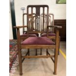 Five oak dining chairs with padded seats, to include one carver