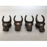 Set of four carved bulls head napkin rings each with inlay