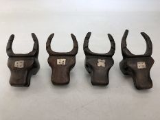 Set of four carved bulls head napkin rings each with inlay