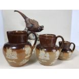 Three Royal Doulton stoneware jugs, the tallest approx 16cm in height, along with a Coalport