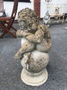 Garden ornament of a Cherub sat on a ball, ideal Finial approx 65cm tall