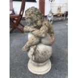 Garden ornament of a Cherub sat on a ball, ideal Finial approx 65cm tall