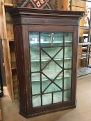 Wall hanging corner cupboard with glazed door