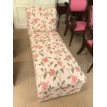 Upholstered chaise longue on castors with floral upholstery, approx 142cm in length