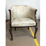 Upholstered bedroom chair on cabriole legs with carved detailing