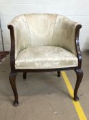 Upholstered bedroom chair on cabriole legs with carved detailing