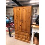 Small pine wardrobe with two hanging rails and two drawers under