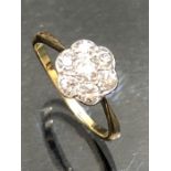 Gold daisy Style ring with seven Diamonds set in Platenum mount.size K.5