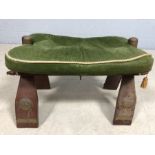 Camel stool with green upholstered seat on brass studded frame